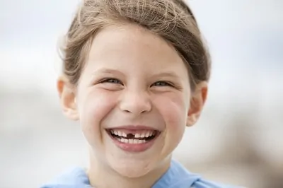 child with missing front tooth