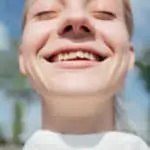 smiling girl with crooked teeth